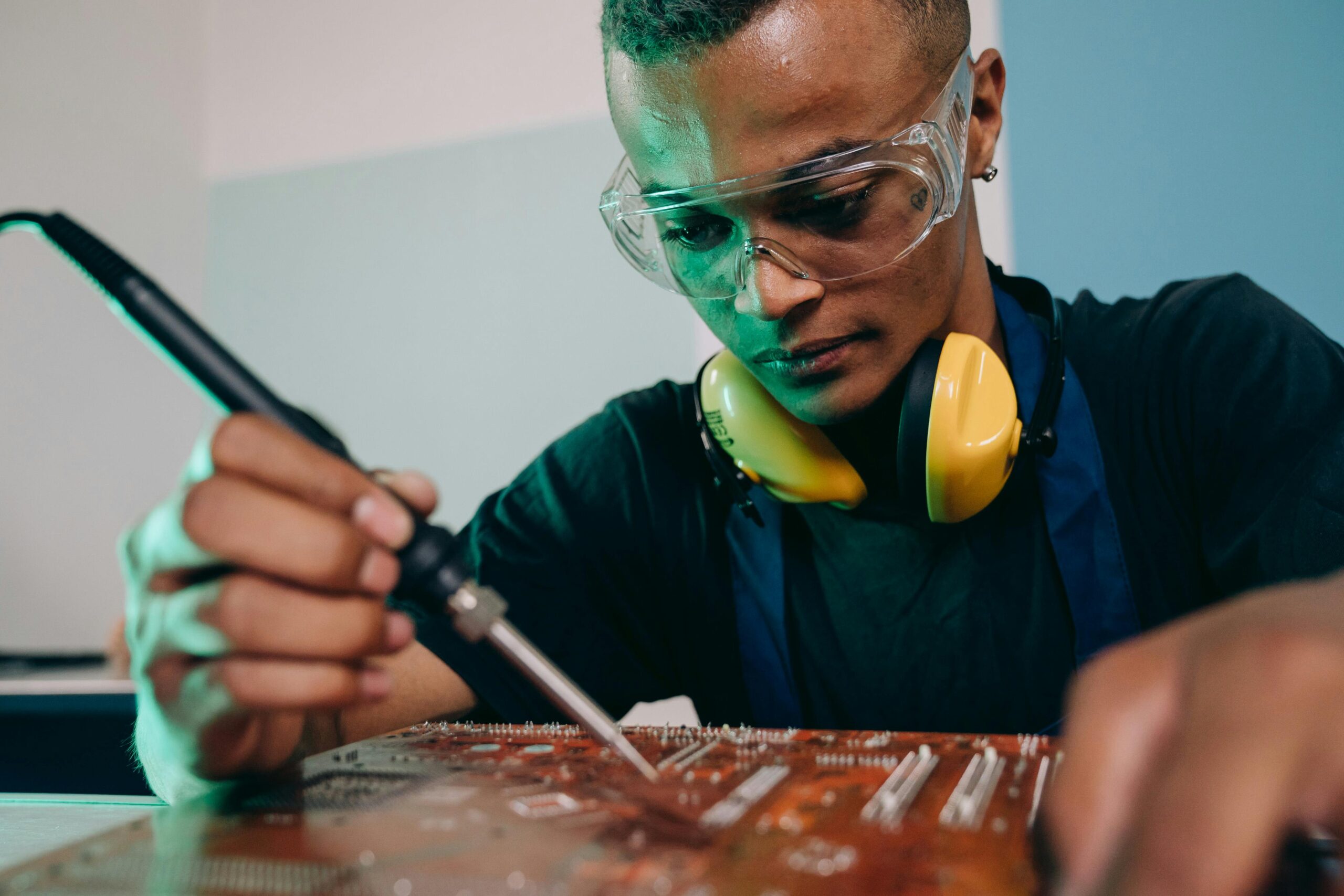 An appliance repair technician doing a diagnostic on an appliance pc board.